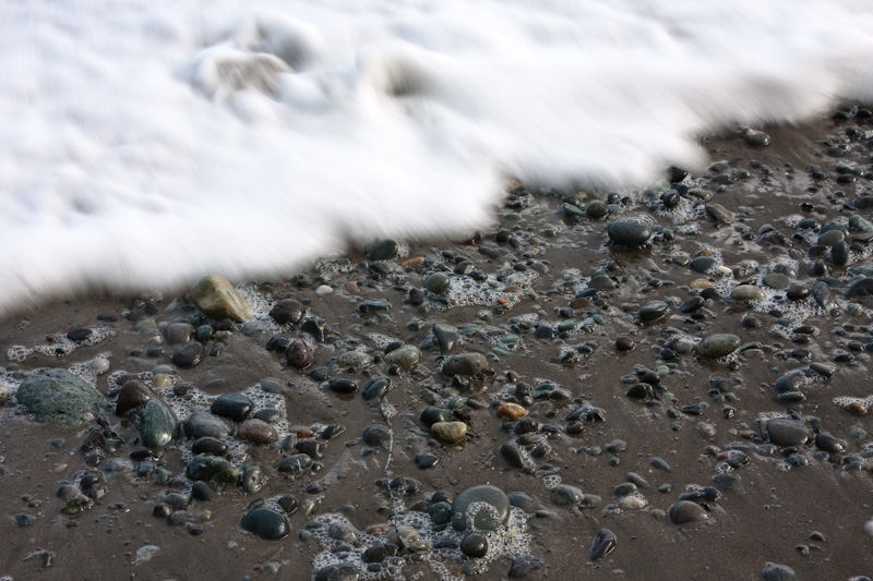 Wave Washing Over Pebbles